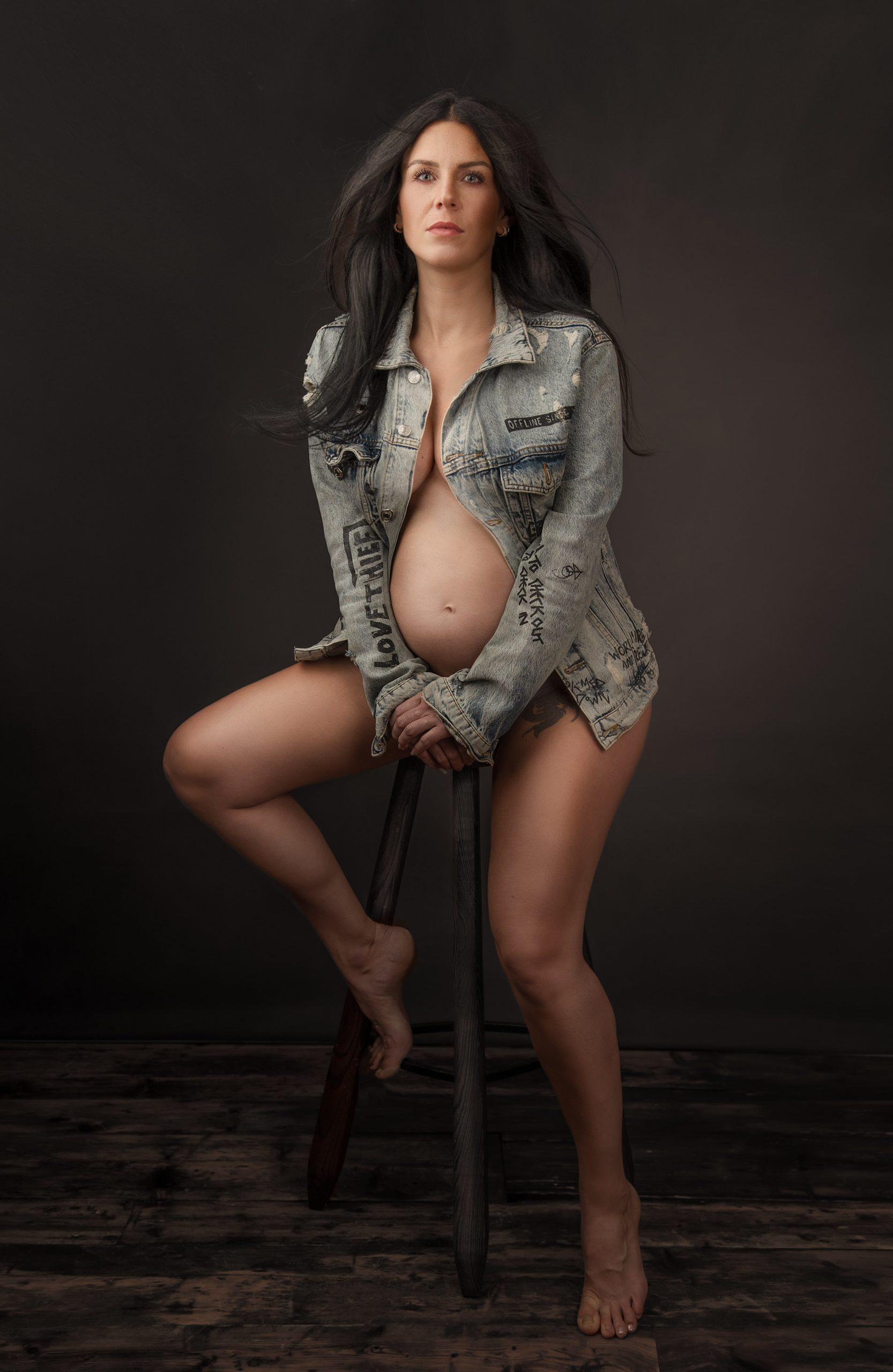pregnant women sat on stool wearing denim jacket